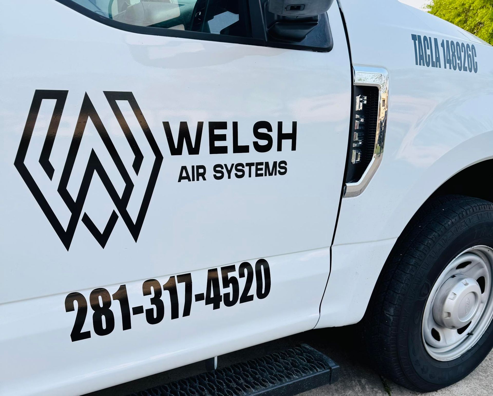 White truck door with Welsh Air Systems logo and phone number 281-314-4520