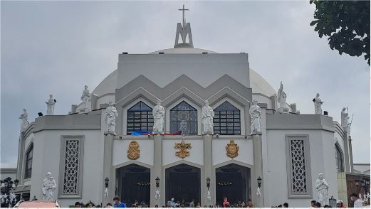 A large white building with a cross on top of it