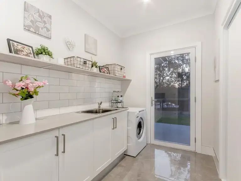 A Laundry Room With Cabinets and a Window — Michael Duncan Constructions Pty Ltd in Burleigh Heads, QLD