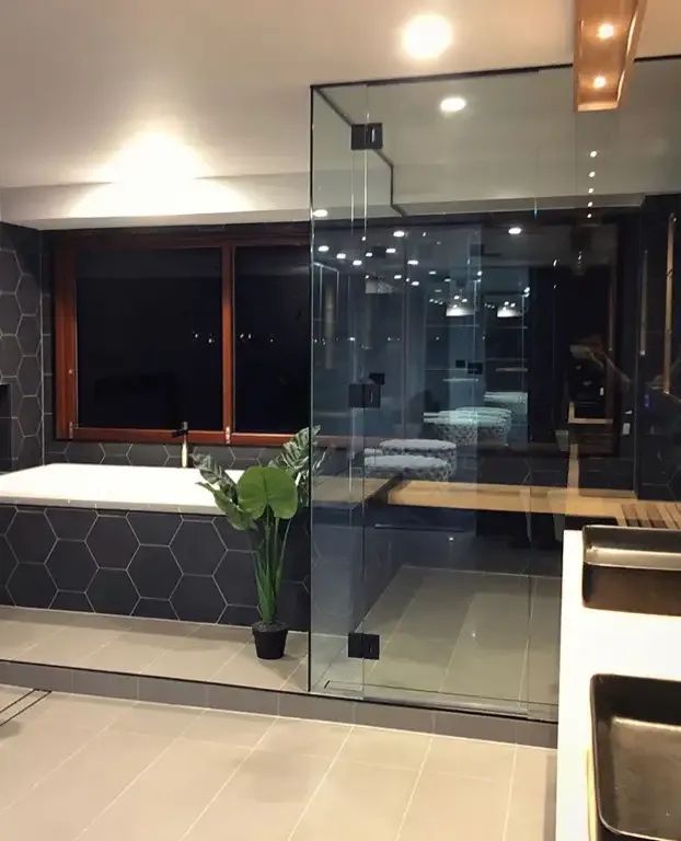 A Bathroom With a Sliding Glass Door and a Tub — Michael Duncan Constructions Pty Ltd in Ashmore, QLD