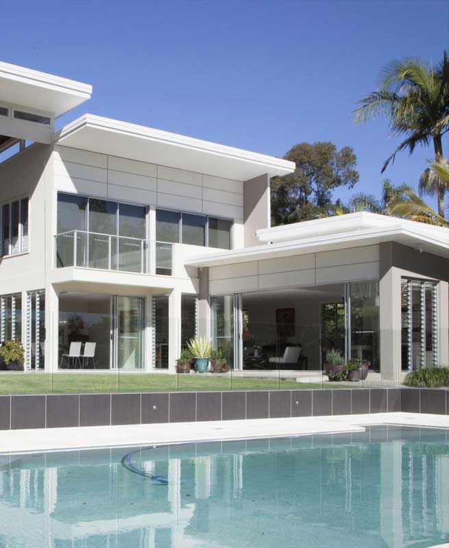 A Bedroom With a Bed and Dresser — Michael Duncan Constructions Pty Ltd in Robina, QLD