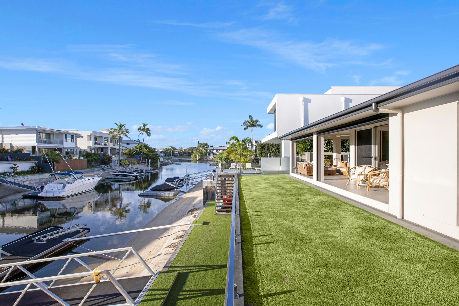 A Patio With a Table and Chairs Next to a Pool at Night — Michael Duncan Constructions Pty Ltd in Robina, QLD