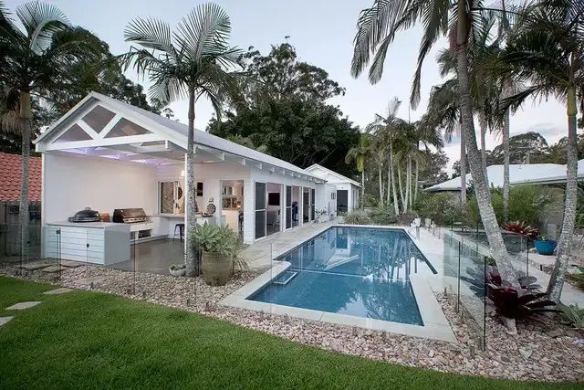 A Large Swimming Pool in the Backyard of a House — Michael Duncan Constructions Pty Ltd in Robina, QLD