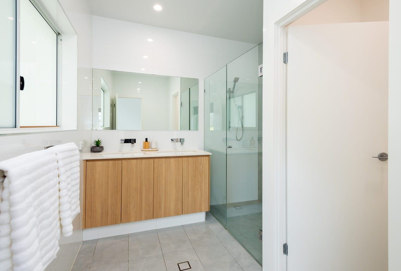 A Bathroom With a Sliding Glass Door and a Tub — Michael Duncan Constructions Pty Ltd in Ashmore, QLD