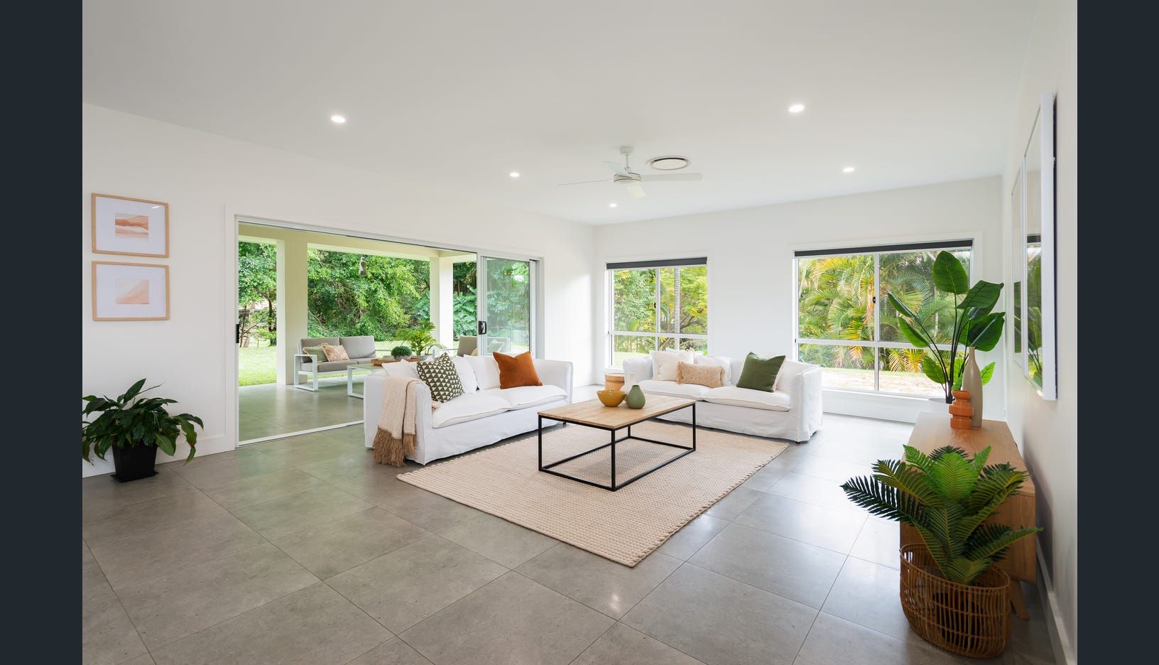 A Living Room With  Chairs and  Kitchen — Michael Duncan Constructions Pty Ltd in Robina, QLD