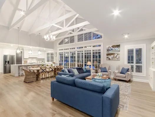 A Living Room With  Chairs and  Kitchen — Michael Duncan Constructions Pty Ltd in Robina, QLD