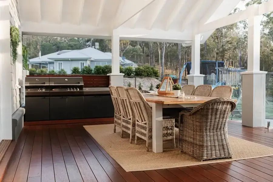 A Patio With a Table and Chairs and a Grill — Michael Duncan Constructions Pty Ltd in Robina, QLD