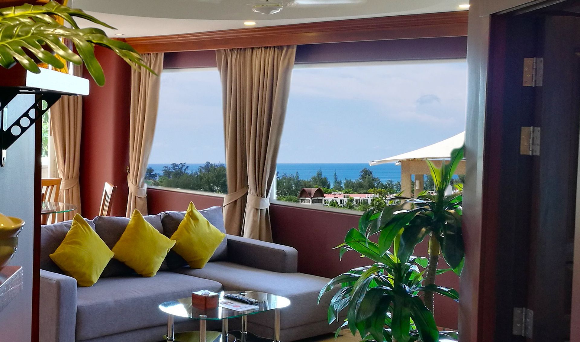 A living room with a couch and a view of the ocean