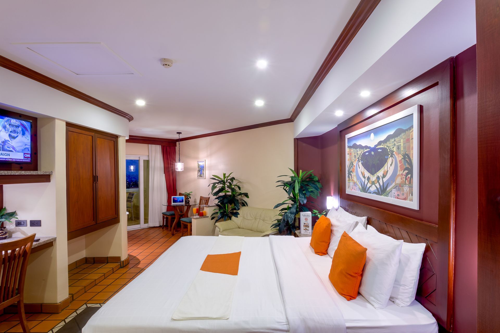 A hotel room with a large bed and a television.