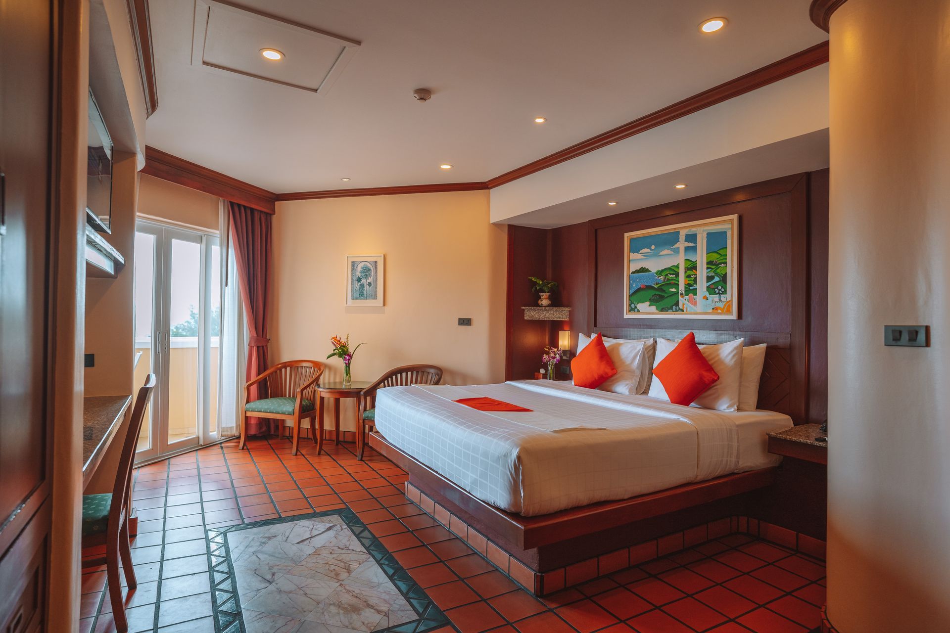 A hotel room with a king size bed and a balcony.