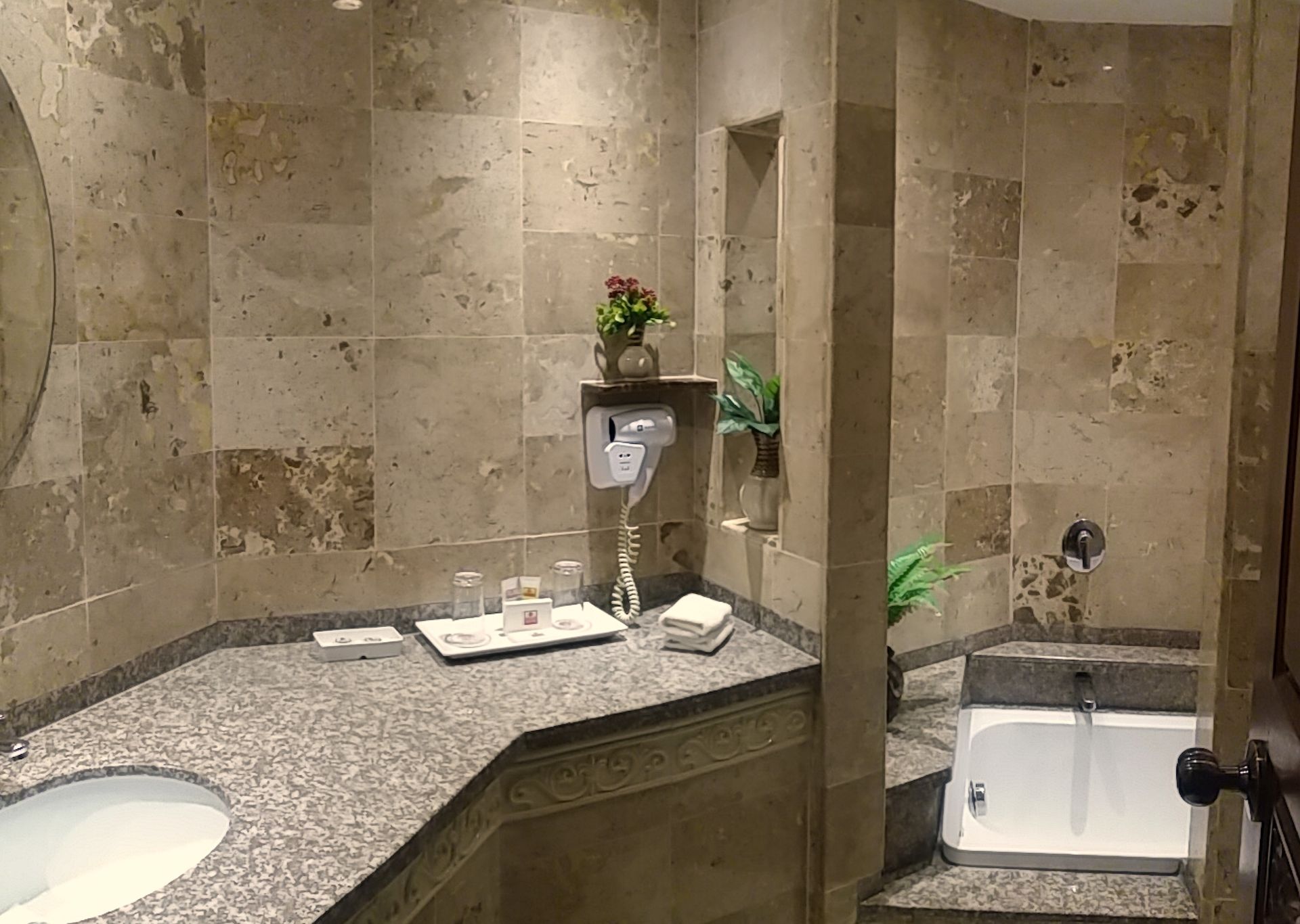 A bathroom with a sink and a bathtub in it