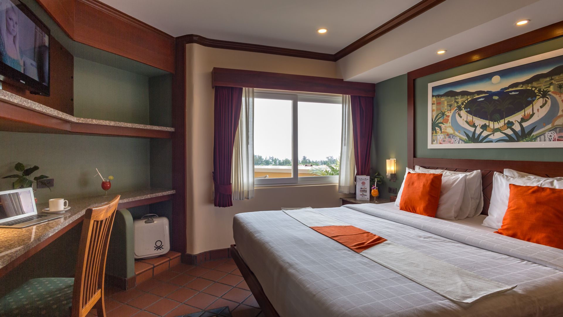 A hotel room with a large bed , desk , chair and television.