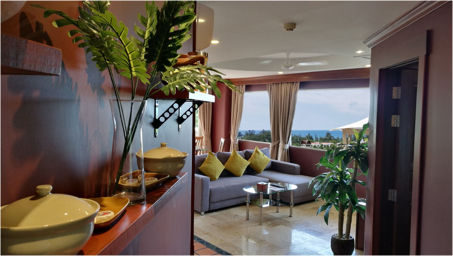 A living room with a couch and a potted plant