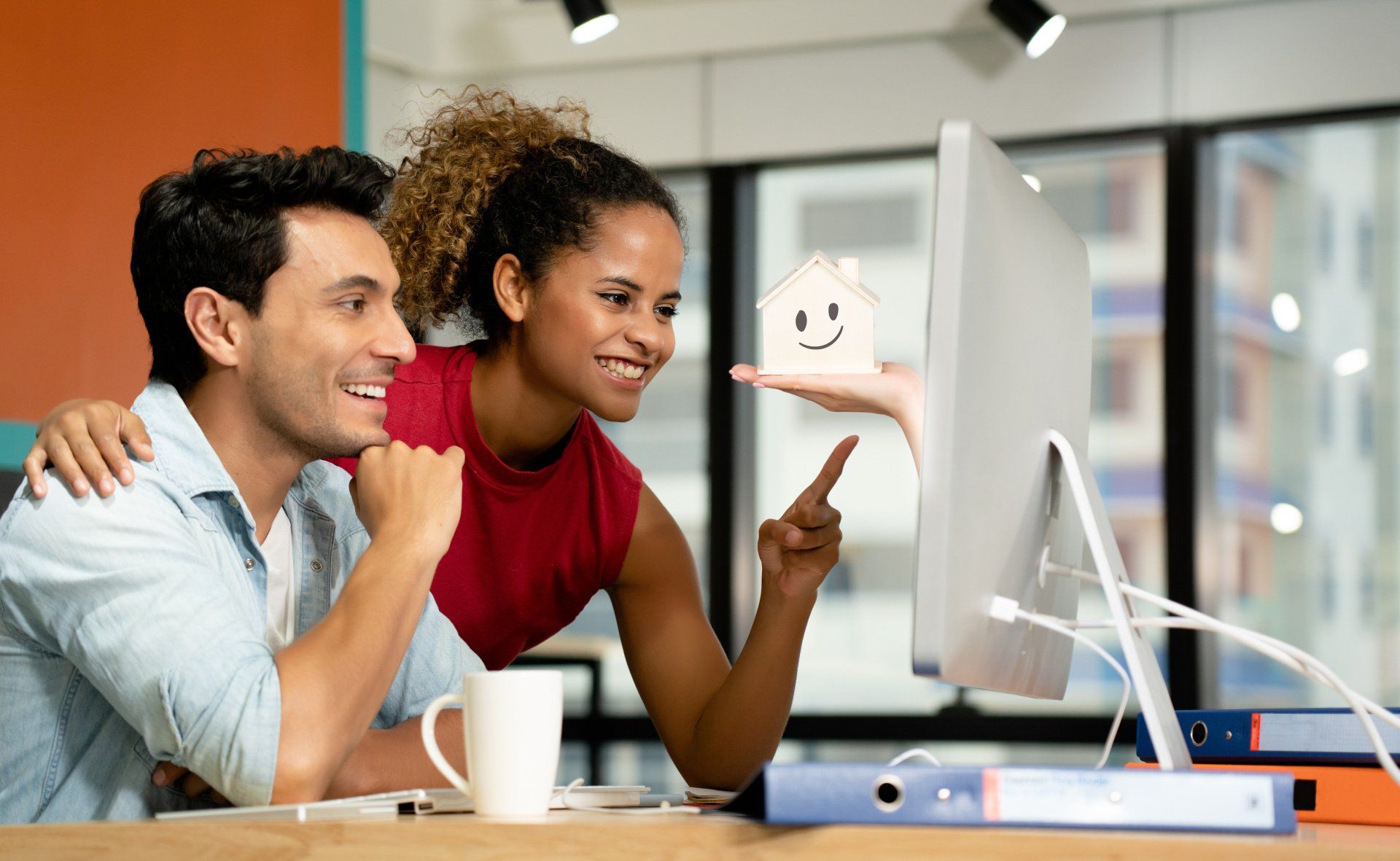 Couple smiling at computer screen