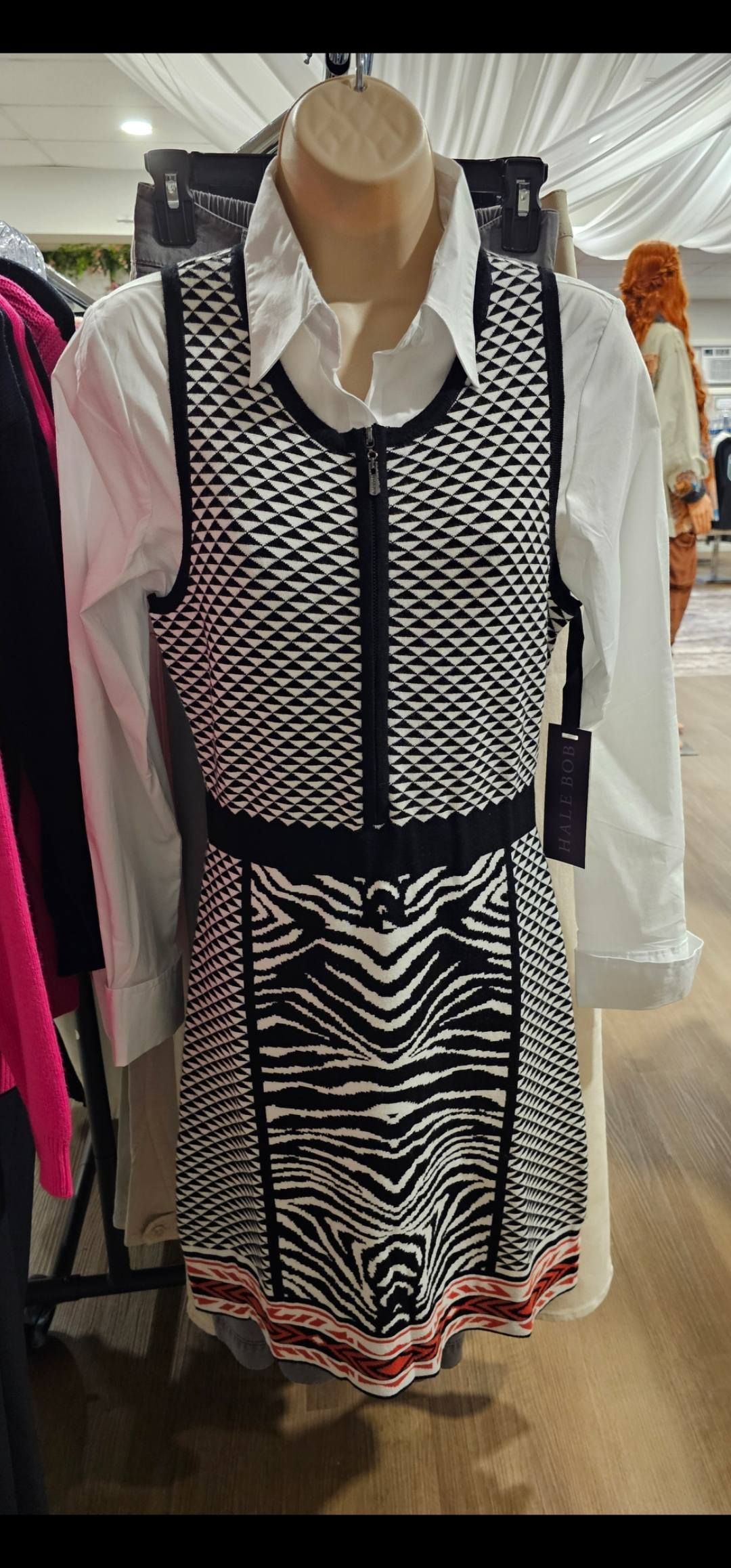 Black-and-white patterned dress displayed on a mannequin in a clothing store.