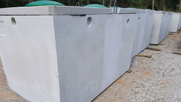 Three concrete rings are stacked on top of each other on a construction site.