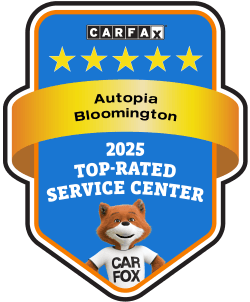 CARFAX badge for Autopia Bloomington, 2025 top-rated service center, blue and gold with Car Fox mascot