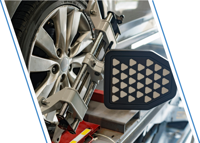 Wheel alignment equipment attached to a vehicle wheel during service.