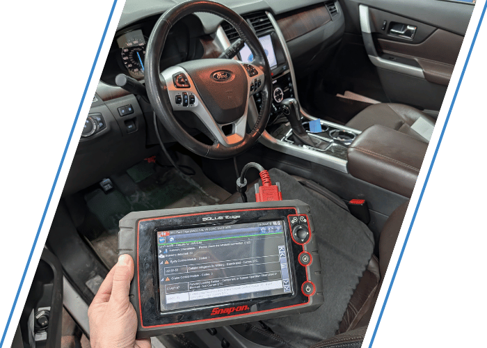 Technician using a professional Snap-on scan tool to perform vehicle diagnostics inside a Ford SUV.