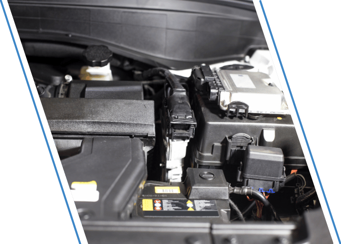 Vehicle battery and electrical control modules inside the engine compartment.