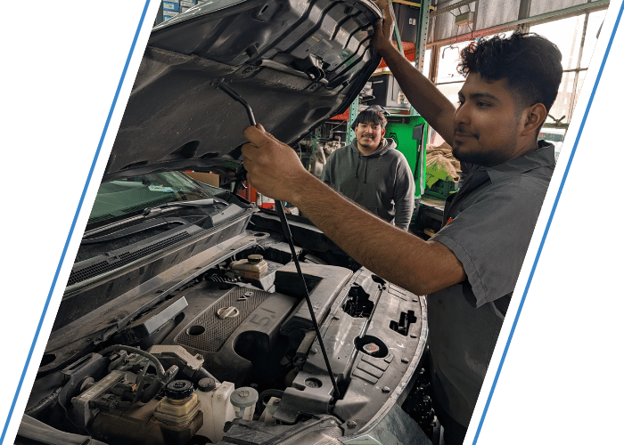 Technician opening the hood of a Nissan SUV to inspect the engine before repairs.