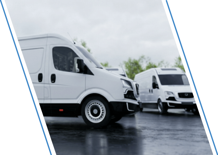 White commercial cargo vans parked together in a fleet lot.