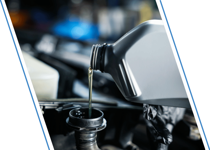 Engine oil being poured into a vehicle during a fluid top-off service.
