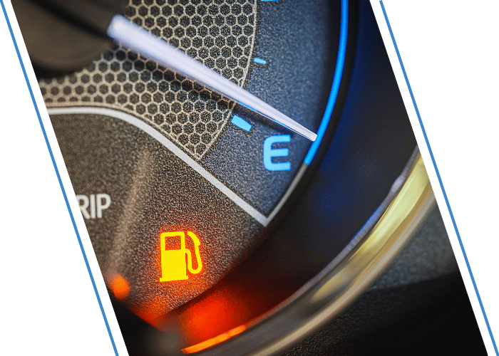 Close-up of a vehicle fuel gauge showing low fuel.