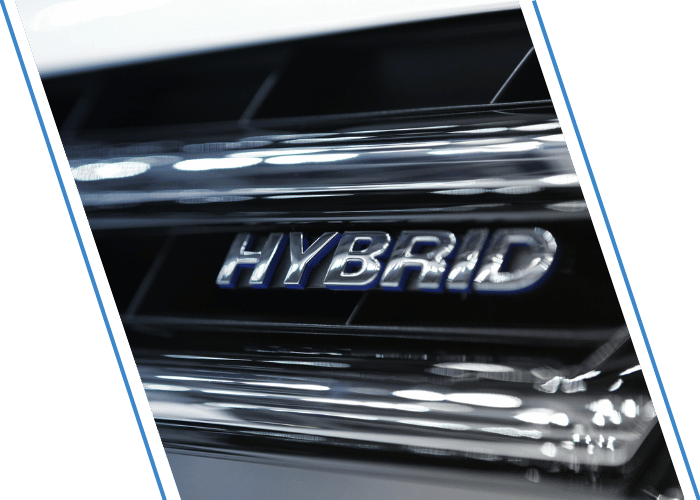 Close-up of a hybrid vehicle badge on the rear of a vehicle.
