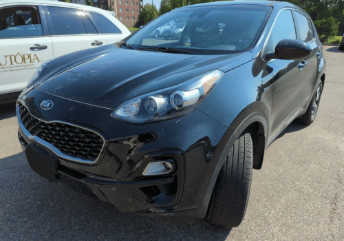 Black Kia Sportage SUV parked outdoors in a parking lot