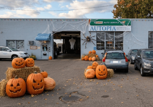 Autopia Automotive repair shop in Bloomington decorated for Halloween with glowing jack-o'-lanterns