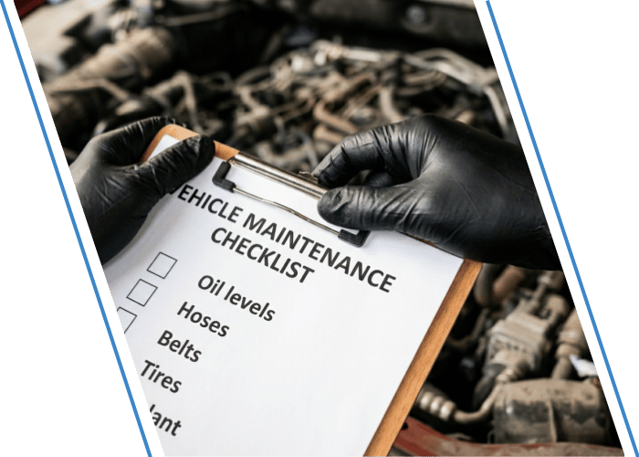 Vehicle maintenance checklist being reviewed in front of an open engine bay.