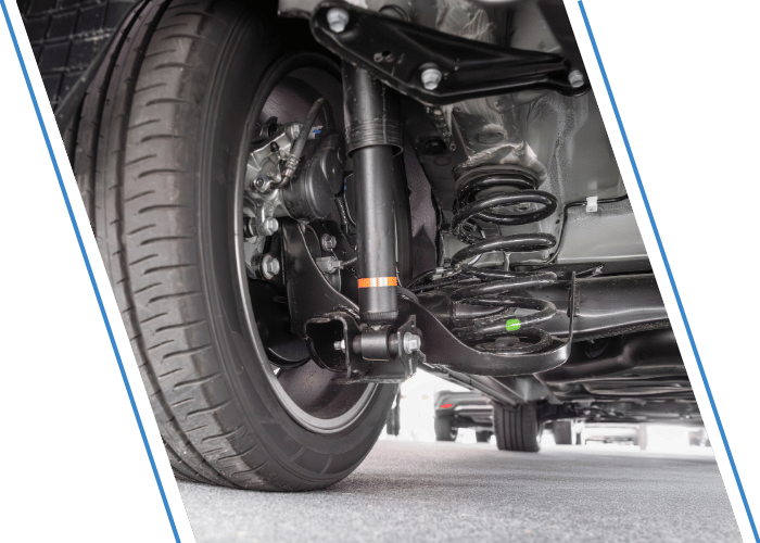 Close-up of a vehicle suspension system showing the coil spring and shock absorber.