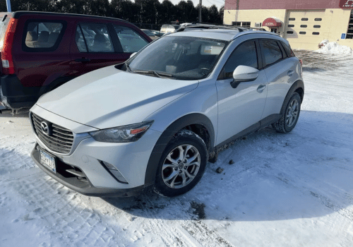 White Mazda CX-3 crossover SUV parked outdoors in a snowy parking lot
