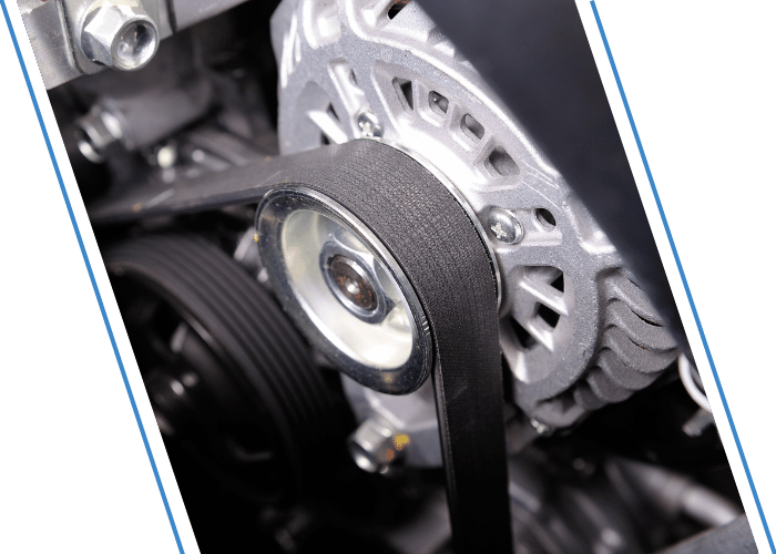 Close-up of a vehicle timing belt and pulley assembly.