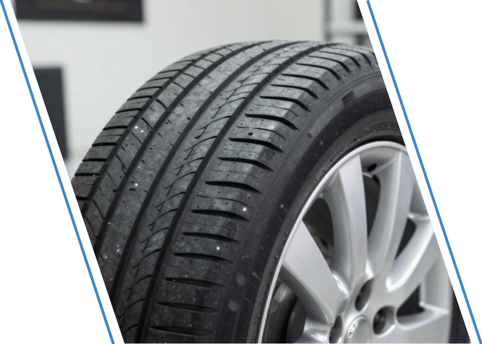 Close-up of a vehicle tire showing tread depth and condition.