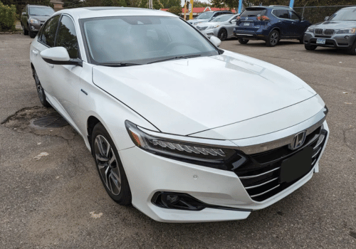 White Honda Accord Hybrid sedan parked outdoors in a parking lot