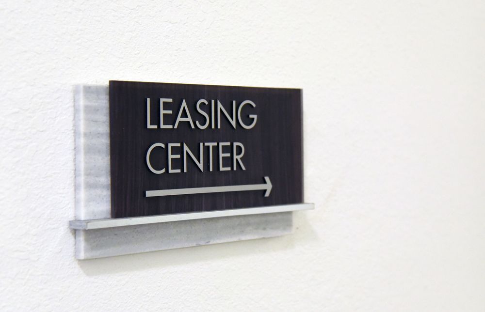 A Sign on A Wall that Says Leasing Center — Hager Surveying In Kingscliff, NSW