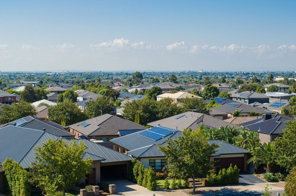 An Aerial View of A Residential Area with Lots of Houses and Trees — Hager Surveying In Palm Beach, QLD