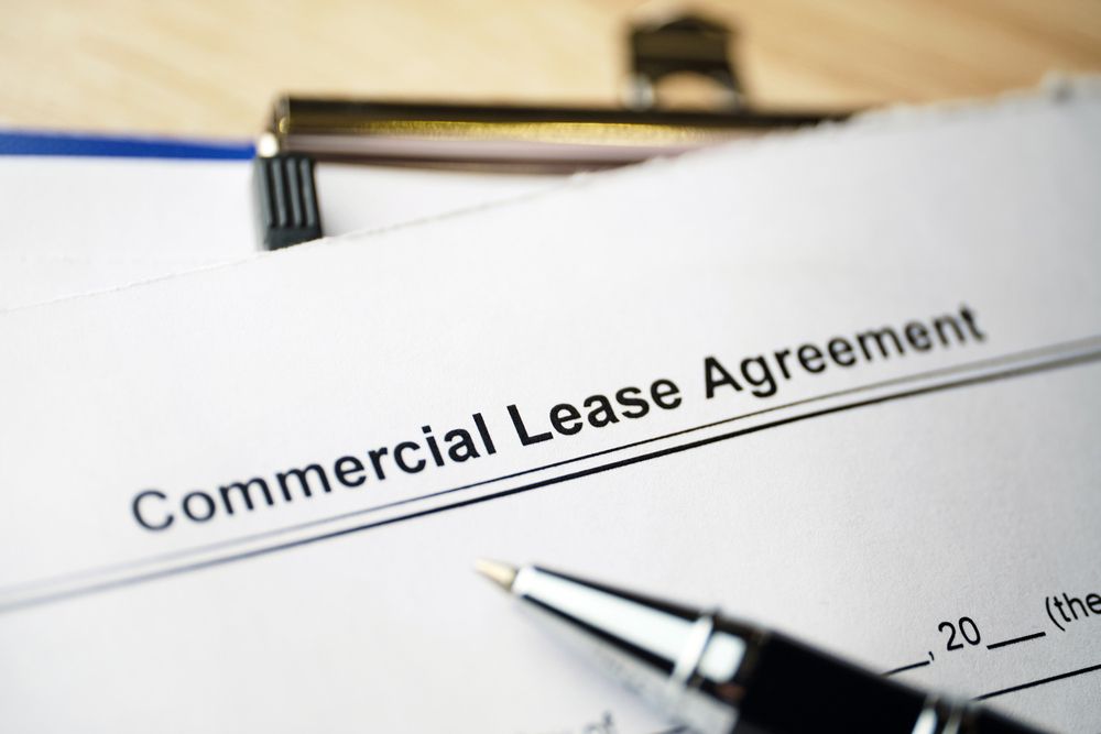 A Pen Is Sitting on Top of A Commercial Lease Agreement — Hager Surveying In Murwillumbah, NSW
