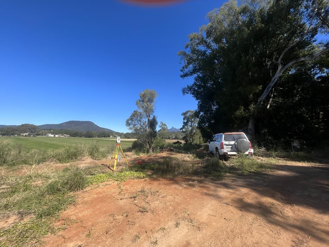 White Truck is Parked on the Side of a Dirt Road — Hager Surveying In Bangalow, NSW