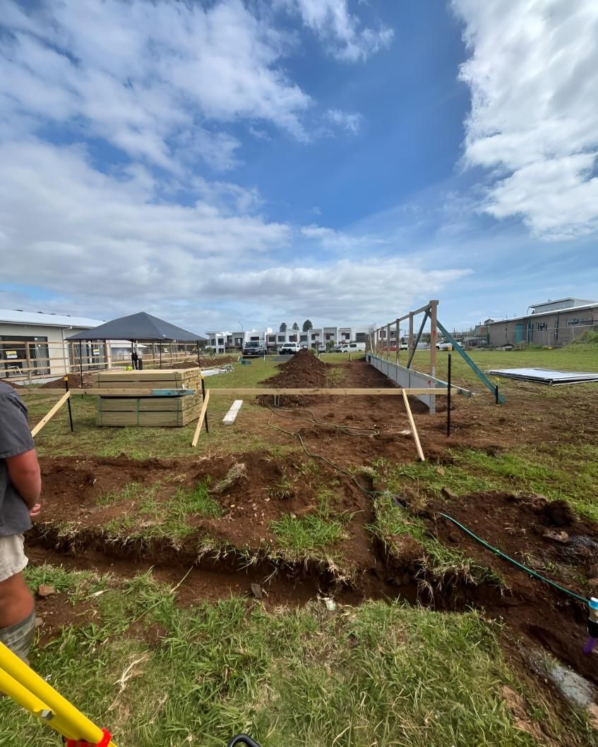 Man is Standing in a Field — Hager Surveying In Coolangatta, QLD