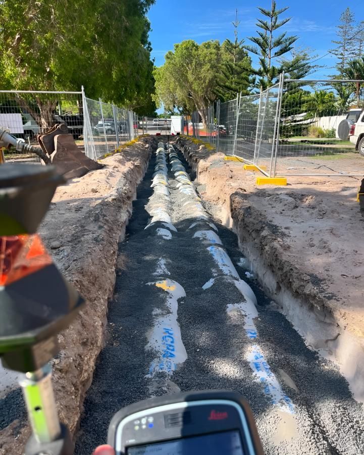 Person is Taking a Picture of a Pipe in the Dirt — Hager Surveying In Currumbin, QLD