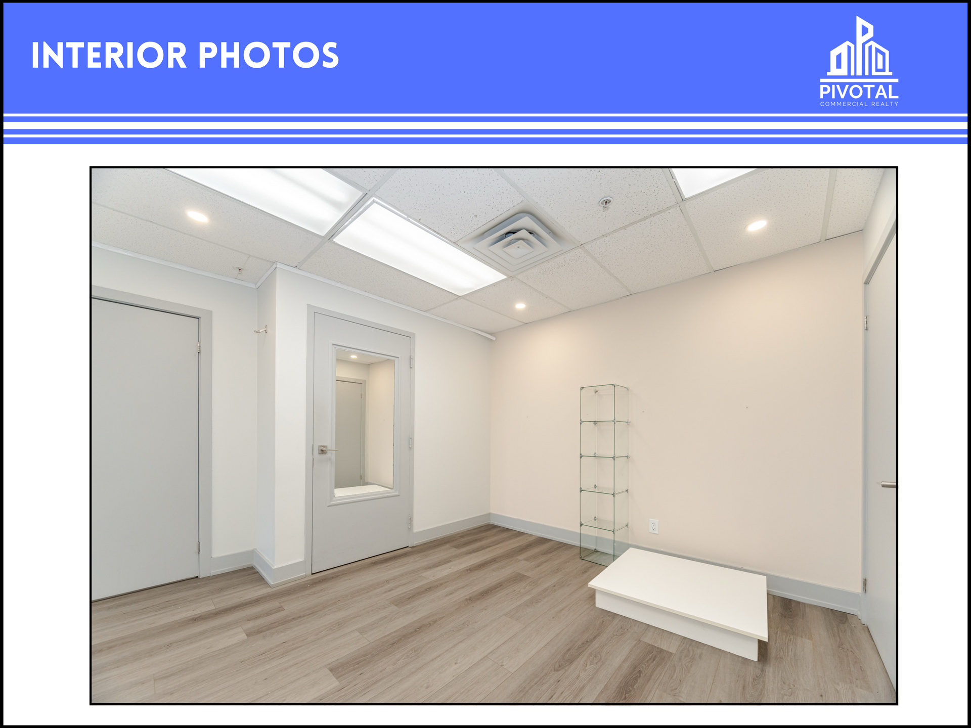 A bright office interior with light wood flooring, white walls, two closed doors, a glass display shelf, and a small bench.