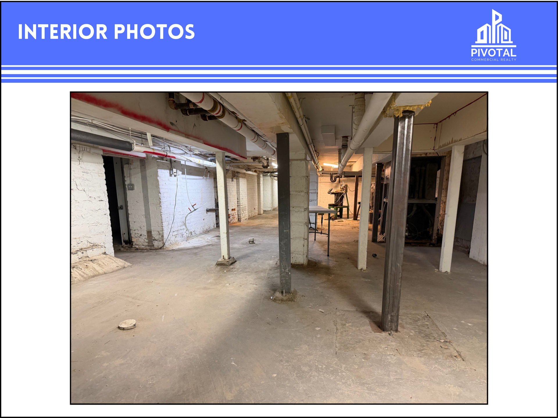 An unfinished basement interior featuring concrete floors, structural steel support columns, and exposed ceiling pipes.