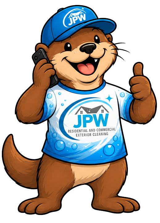 Cartoon otter mascot in a blue JPW cap and shirt, smiling and giving a thumbs-up while holding a phone.