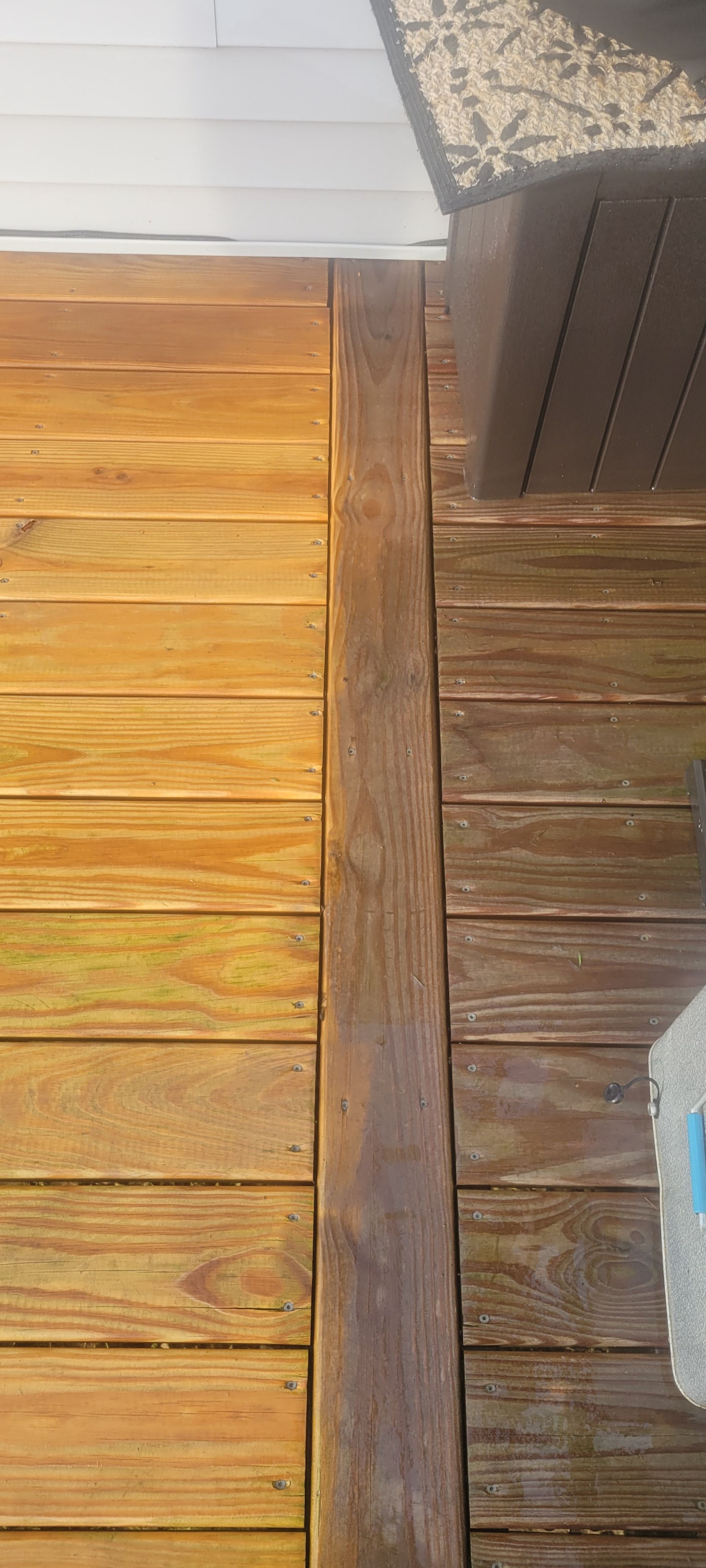 Wooden deck with sections of contrasting color.