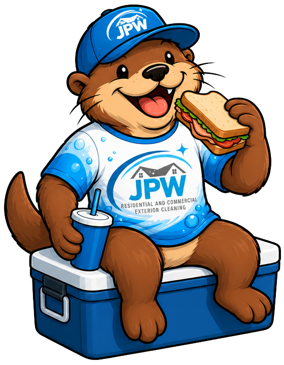 Cartoon otter in blue JPW cap and shirt eating a sandwich while sitting on a blue cooler with a drink cup.