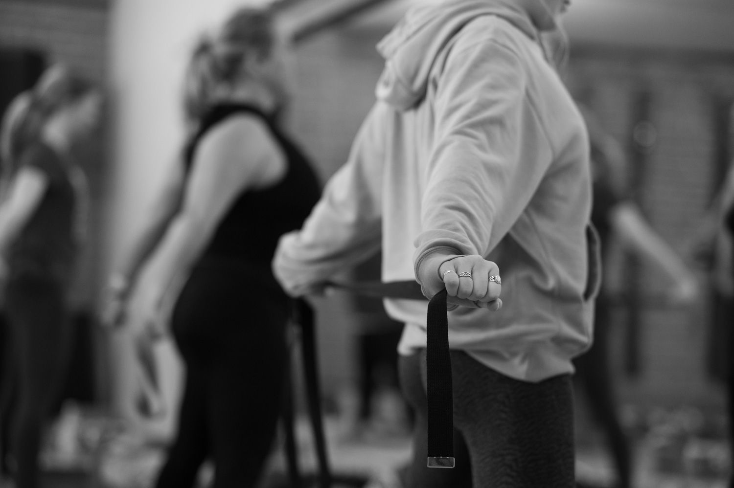 Person in yoga pose, hands reaching toward feet on a mat.