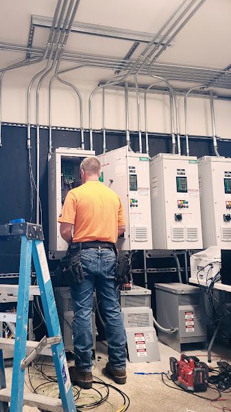ACT electrician replacing a variable frequency drive